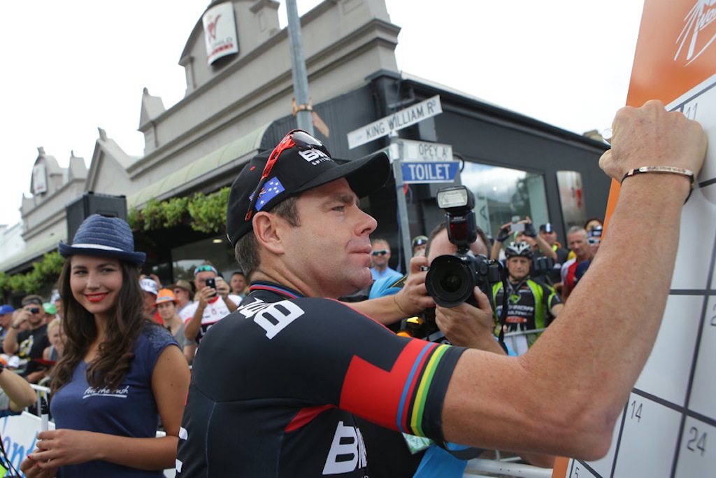 Ever the crowd favourite, Cadel Evans signs on at the start of stage 2.