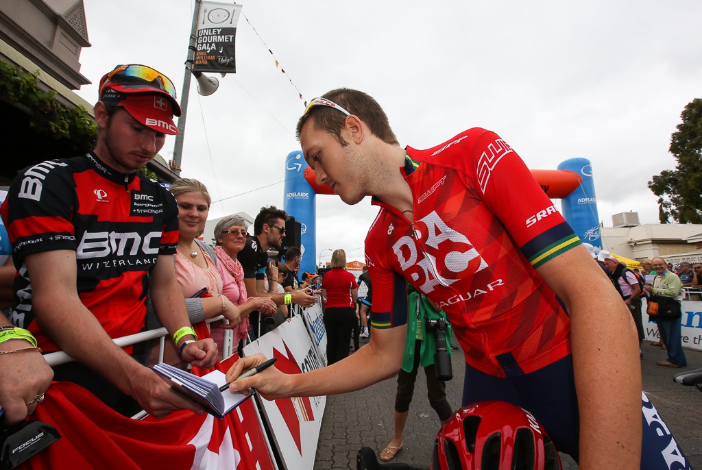 Former Australian national champion Travis Meyer signs autographs at the start.