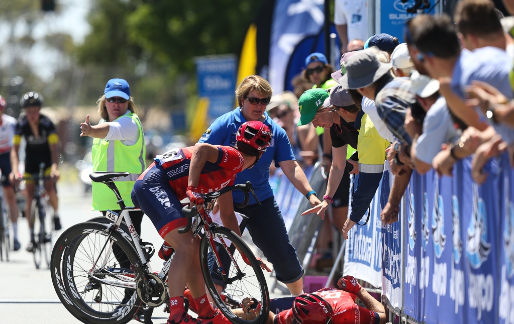 Jones is attended to by his teammate Adam Phelan and his mother, Karin Jones, a project manager at Cycling Australia who was working on the race.