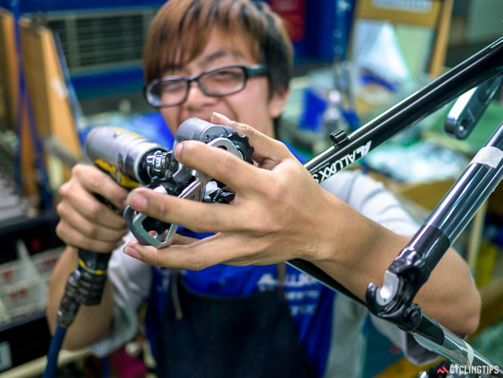 Attaching a rear mech in the factory.