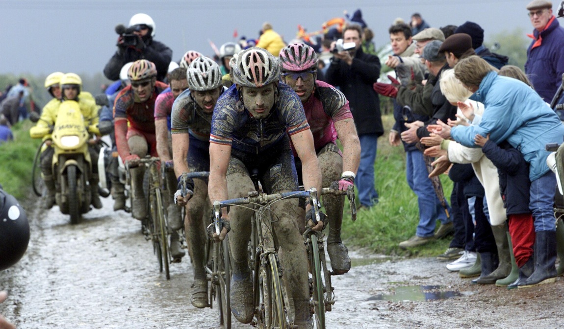 A mud-encrusted George Hincapie leads the bunch in the 2002 Paris-Roubaix.