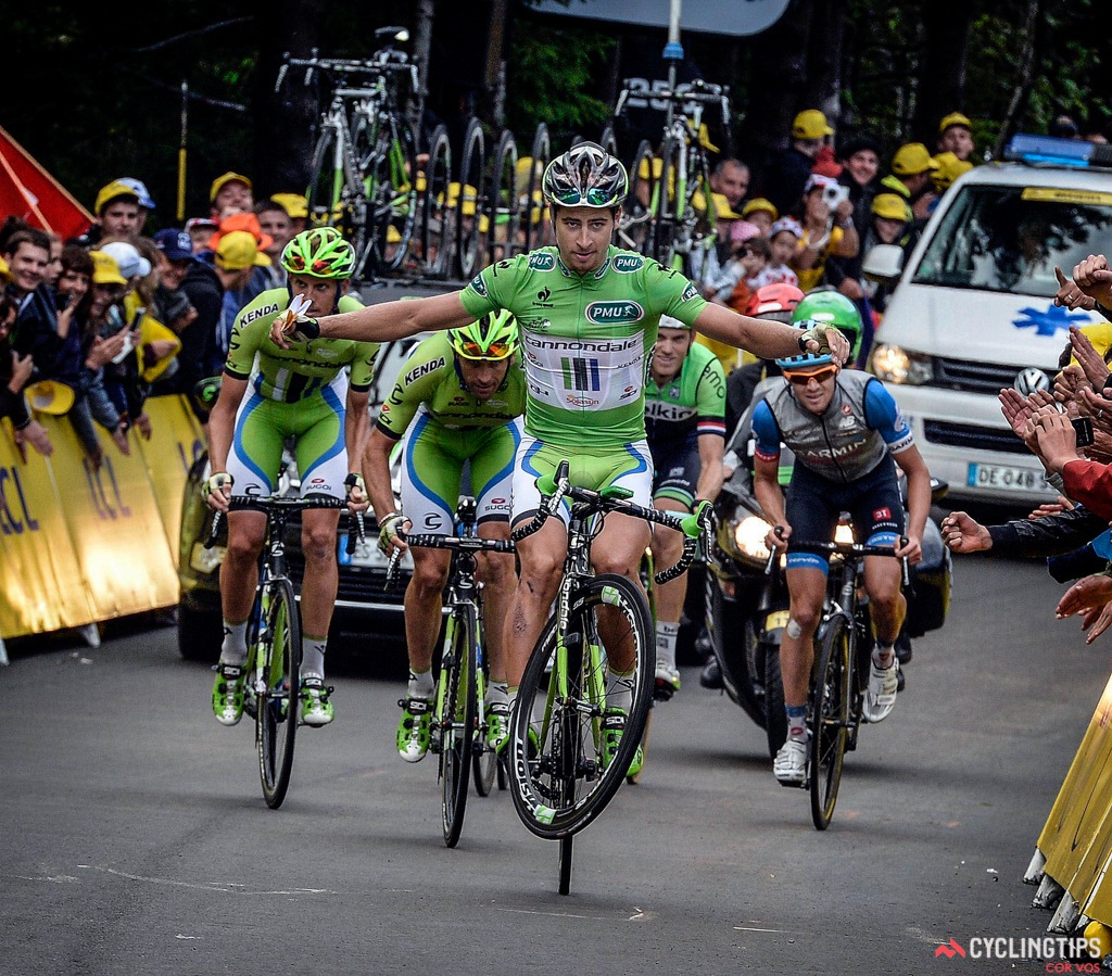 Peter Sagan pulling a one-handed wheelie on top of La Planche des Belles Filles.